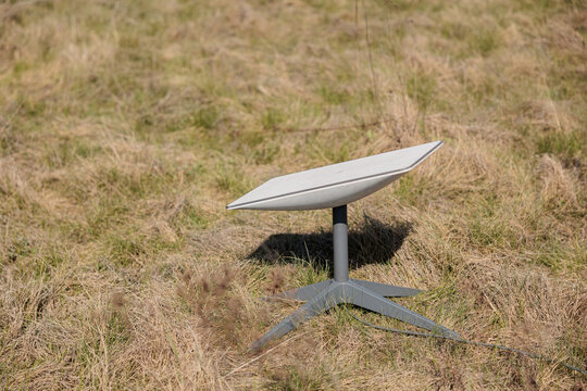Starlink space signal receiver in a grass field. Starlink is a satellite internet constellation operated by SpaceX internet