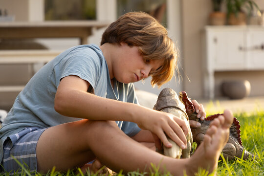 12 year old boy playing with toys in back yard