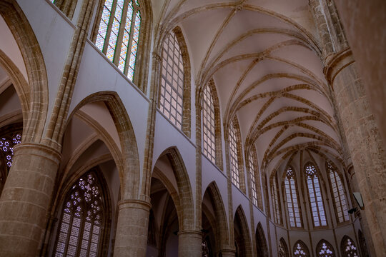 Vaulted arches and tall stained-glass windows illuminate the interior of Lala Mustafa Pasha Mosque (formerly St. Nicholas Cathedral) in Famagusta, Northern Cyprus, showcasing remarkable Gothic medieva