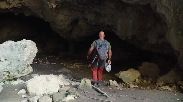 Hiker exploring a dark cave.