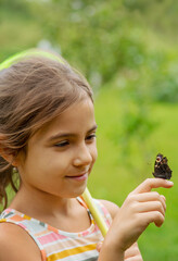 The child catches butterflies in nature. Selective focus. ,