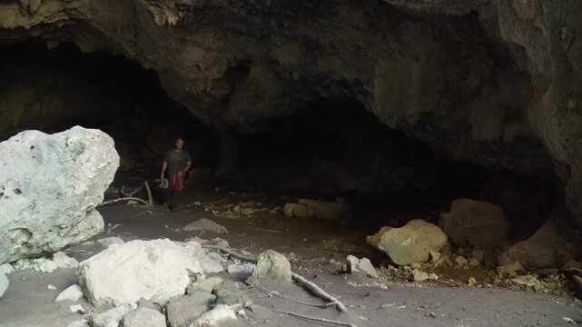 Hiker exploring a dark cave.