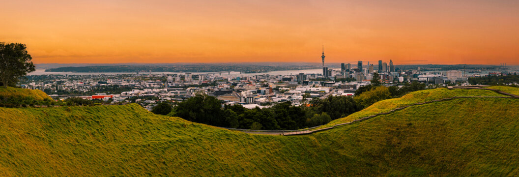 Mount Eden, Maungawhau mountain peak landscape at summer sunset with Auckland city skyline in New Zealand