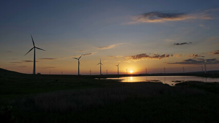 Obraz premium Windmills turbines at sunset