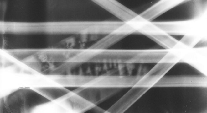 Abstract Light Beams Crossing on Dark Background with Grunge Texture