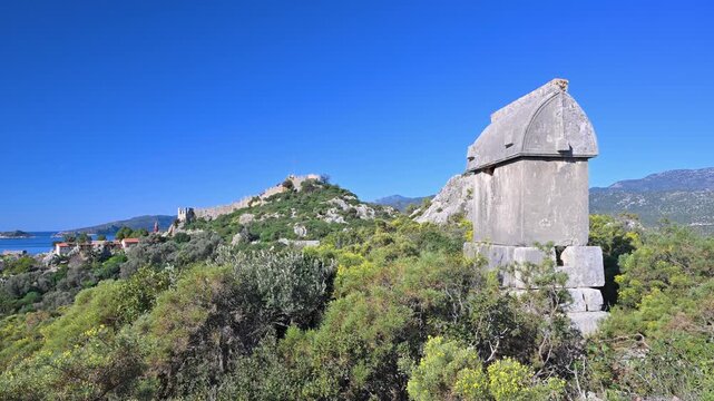 Ancient Lycian sarcophagus with Simena Castle landscape in Turkey