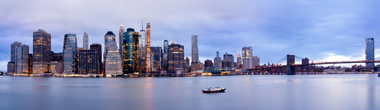 Panoramic View of Lower Manhattan Skyline and Brooklyn Bridge at Blue Hour, New York City.