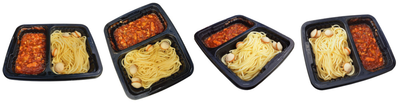 Various plastic trays of instant pasta meals with spaghetti, sausages, and tomato sauce, ready to eat.