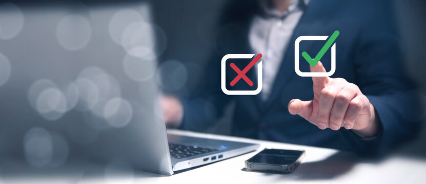 Select the check mark on a laptop. Check right and wrong marks. Concept decide to choose vote. Yes or no decisions, and business options for difficult situations in dilemma