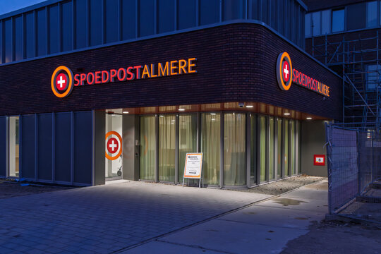 Almere, Netherlands, 14 March 2026. The illuminated entrance of the "Spoedpost Almere" emergency healthcare facility during the evening hours.