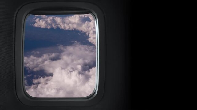 view from the airplane window of clouds floating in the daytime