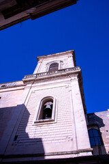 Obraz premium The majestic bell tower of Lecce Cathedral, in siuthern Italy, rising above the Baroque skyline of the historic city. 