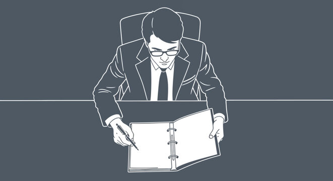 Businessman writing notes in a binder at an office desk