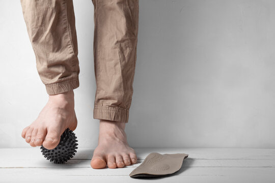 Front view of foot correction with orthopedic insole and massage ball
