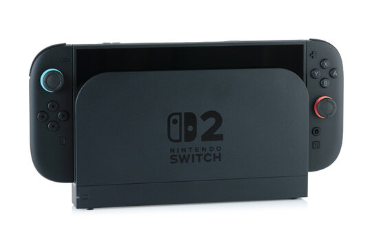 Nintendo Switch 2 gaming console in dock station for stationary home gameplay, isolated on transparent background with natural reflection