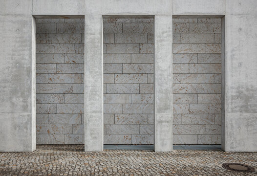 Stone-Clad Building Facade with Concrete Pilasters
