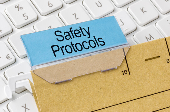 A brown file folder labeled with Safety Protocols