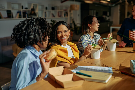 Diverse women colleagues enjoying lunch break together