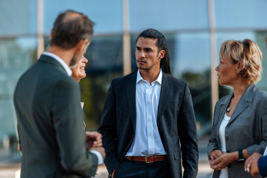 Business professionals having outdoor corporate meeting and discussion