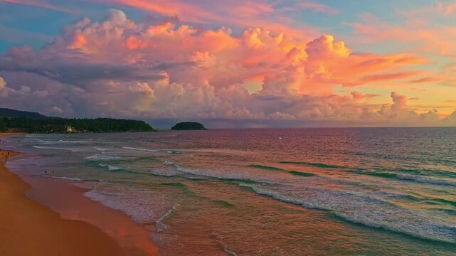 Aerial view of A breathtaking view of the sun setting over the ocean, casting warm golden hues across the waves and clouds while people enjoy the tranquil shoreline. Poo island Kata beach Phuket