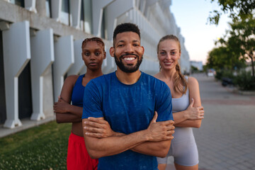 Diverse athletes smiling together outdoors urban setting