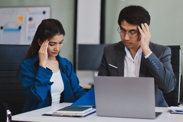 Obraz premium Millennial Asian stressed depressed worried thoughtful professional male businessman female businesswoman employee staff in formal business suit sitting thinking solving problem ideas in office room