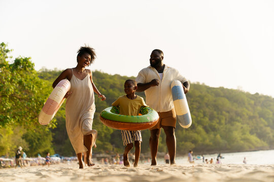 African American parents and son enjoying summer vacation at sea