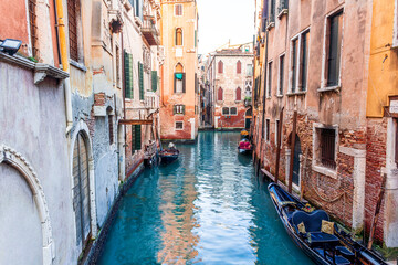 romantic view of a canal in Venice with boats and blue water and beautiful vintage buildings around the cityscape © Yaroslav