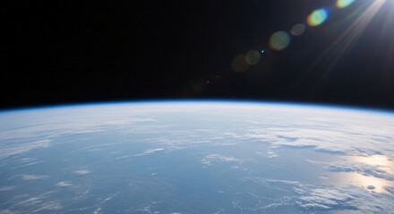 Fototapeta premium Earth seen from space with sun glare and clouds.