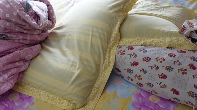 Comfortable bed with multiple pillows and neatly folded blankets.