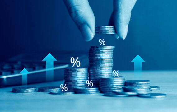 Investor stacking coins with percentage icons and upward arrows, concept of compound interest, tax planning, and high yield investment return