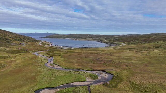 High aerial drone flying away from K&aring;fjord tundra river valley