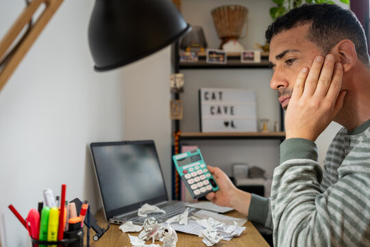 Entrepreneur calculating finances facing economic crisis debt