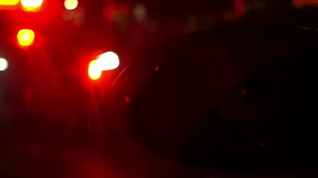 Police patrol car with flashing red and white emergency lights at night. Visible "Police" text on lightbar. Cinematic law enforcement response and public safety concept.