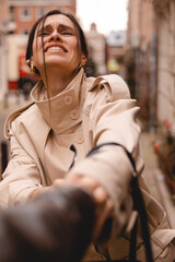 Fototapeta premium Point of view shot of a young woman victim desperately struggling and screaming as a thief pulls her bag on a city street, urban robbery scene, crime and safety concept, emotional portrait