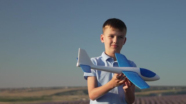 Boy toy plane lavender field young enthusiast examining glider airplane model outdoors against blue summer sky