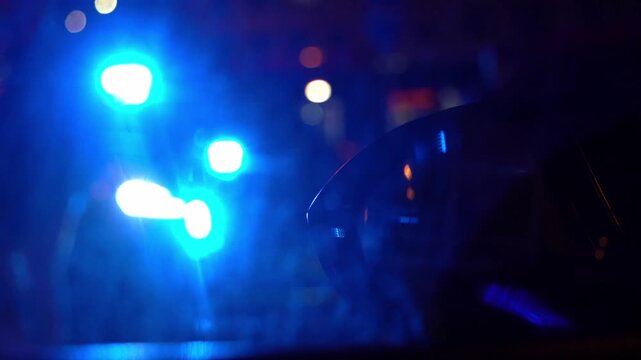 Police patrol car with flashing red and white emergency lights at night. Visible "Police" text on lightbar. Cinematic law enforcement response and public safety concept.