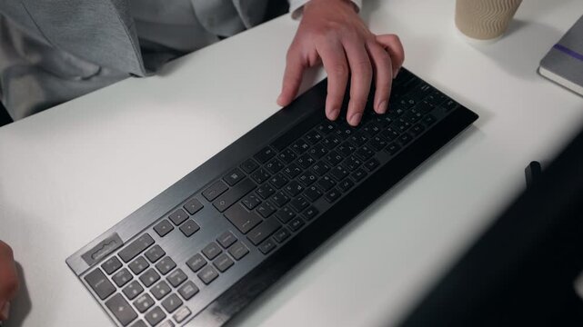 Close up male hands typing computer keyboard top view unrecognizable business man working with internet technology online device chatting businessman guy developer programming cyberspace in office