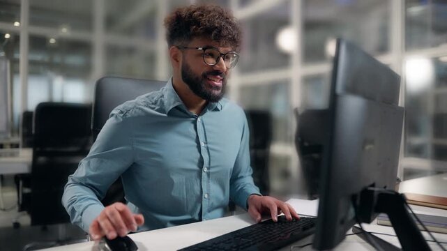 Hindu male worker Arabian business man winning with computer happy in office ethnic businessman win with desktop receiving good offer approved online project male worker guy finishing job successful