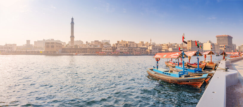 12 January 2026, Dubai, UAE: Traditional abra boats waiting for passengers on Creek, with the historic Bur Dubai skyline and mosque minaret in the background
