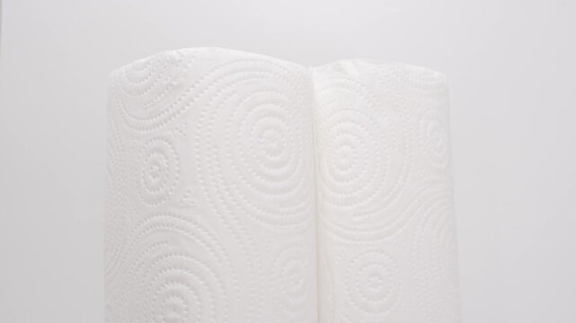 Stacking paper towels in a kitchen setting with white background and plain holder during daytime