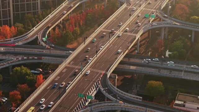 Aerial view of multilevel highway interchange with car and bus traffic in China during the sunset