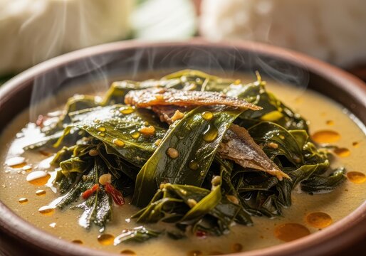 Gulai daun singkong, indonesian cassava leaves cooked in coconut milk with salted fish, traditional dish