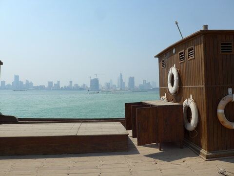 Bahrain, Muharraq - abstract view at Bahrain Pearling Path Museum with dhow in the foreground and skyline in the background