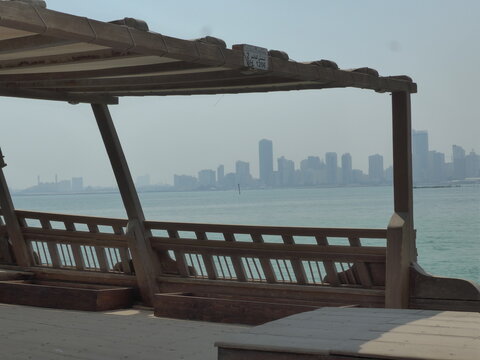 Bahrain, Muharraq - abstract view at Bahrain Pearling Path Museum with dhow in the foreground and skyline in the background