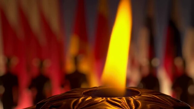 Flickering flame in a decorative holder with blurred flags in the background. Symbolizes remembrance, honor, and patriotism in commemorative events