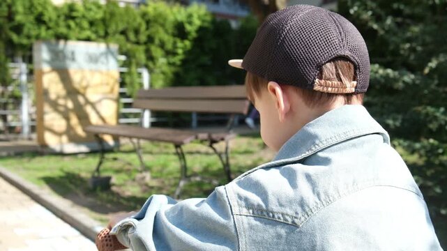 Toddler at balance bike at sunny spring day