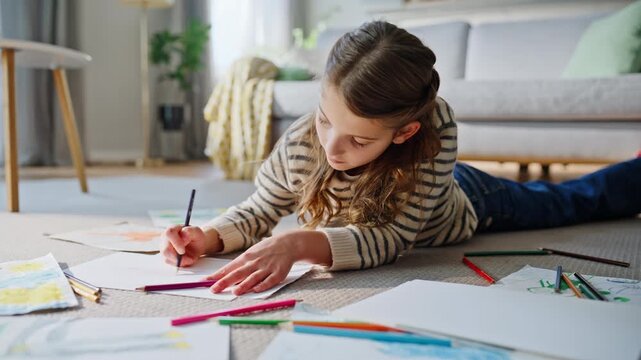 Closeup imaginative girl drawing at home floor closeup. Child crafting image