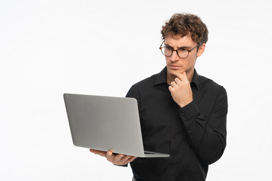 Laptop, thinking and business man in studio for ideas, problem solving and solution on white background. Corporate, professional and person on digital tech for networking, website review and research