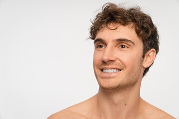 Fototapeta premium Beauty, skincare and portrait of man in studio for salon, grooming dermatology. Cosmetics, glow and self care with person and facial on white background for hydration, hygiene and shine, copy space